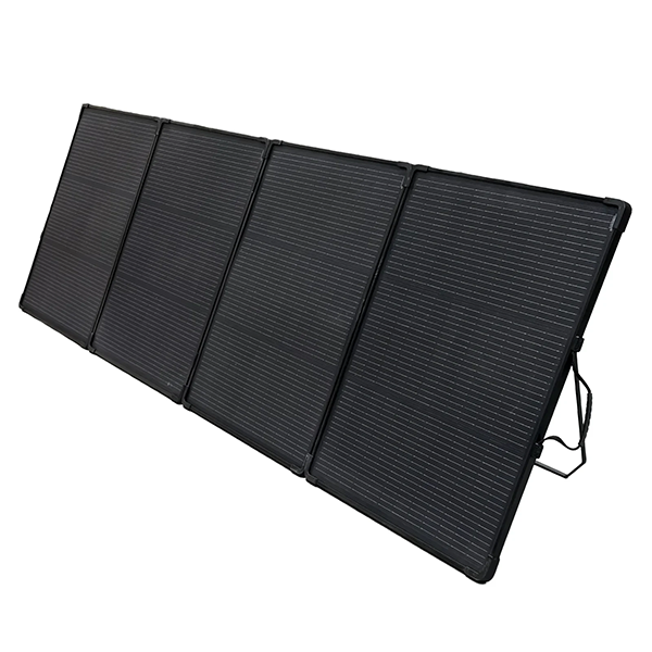 A black foldable portable solar panel with four connected panels, shown at an angle on a plain white background.