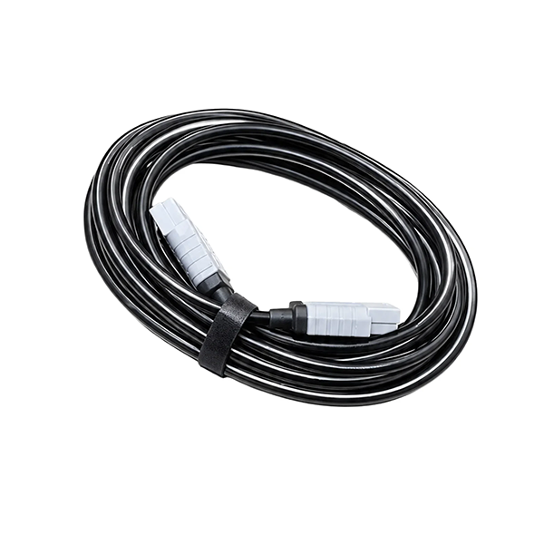 A coiled black cable secured with a black strap, featuring white and black connector ends, shown on a plain white background.