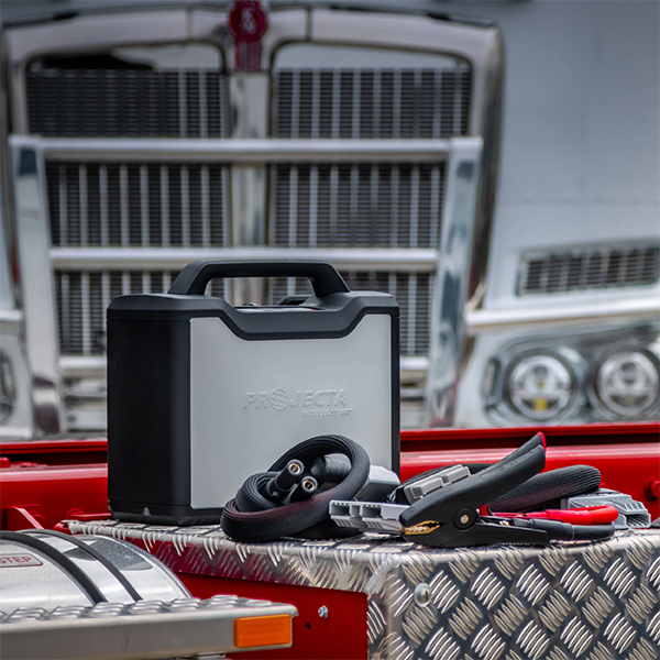Projecta IS5000 Industrial Jump Starter on truck bed with a truck in the background
