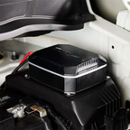 Projecta IDC25XIQ DCDC battery charger attached to a car battery inside a vehicle.