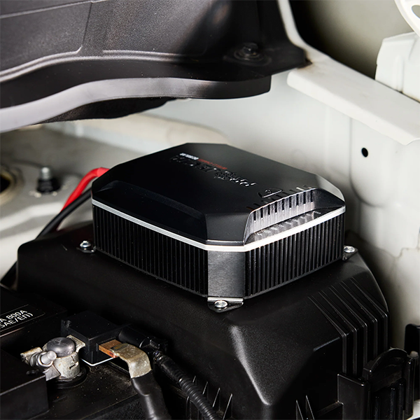 Projecta IDC25XIQ DCDC battery charger attached to a car battery inside a vehicle.